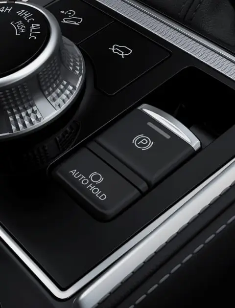 The electric parking brake is situated right by the 4WD Drive Mode Selector dial. It`s easy to operate: simply pull the switch up to apply the parking brake, or push the switch down to release. If the Brake Auto Hold (BAH) function is active, the vehicle will remain stationary even if you release the brake pedal. Pressing the accelerator will release the brake.