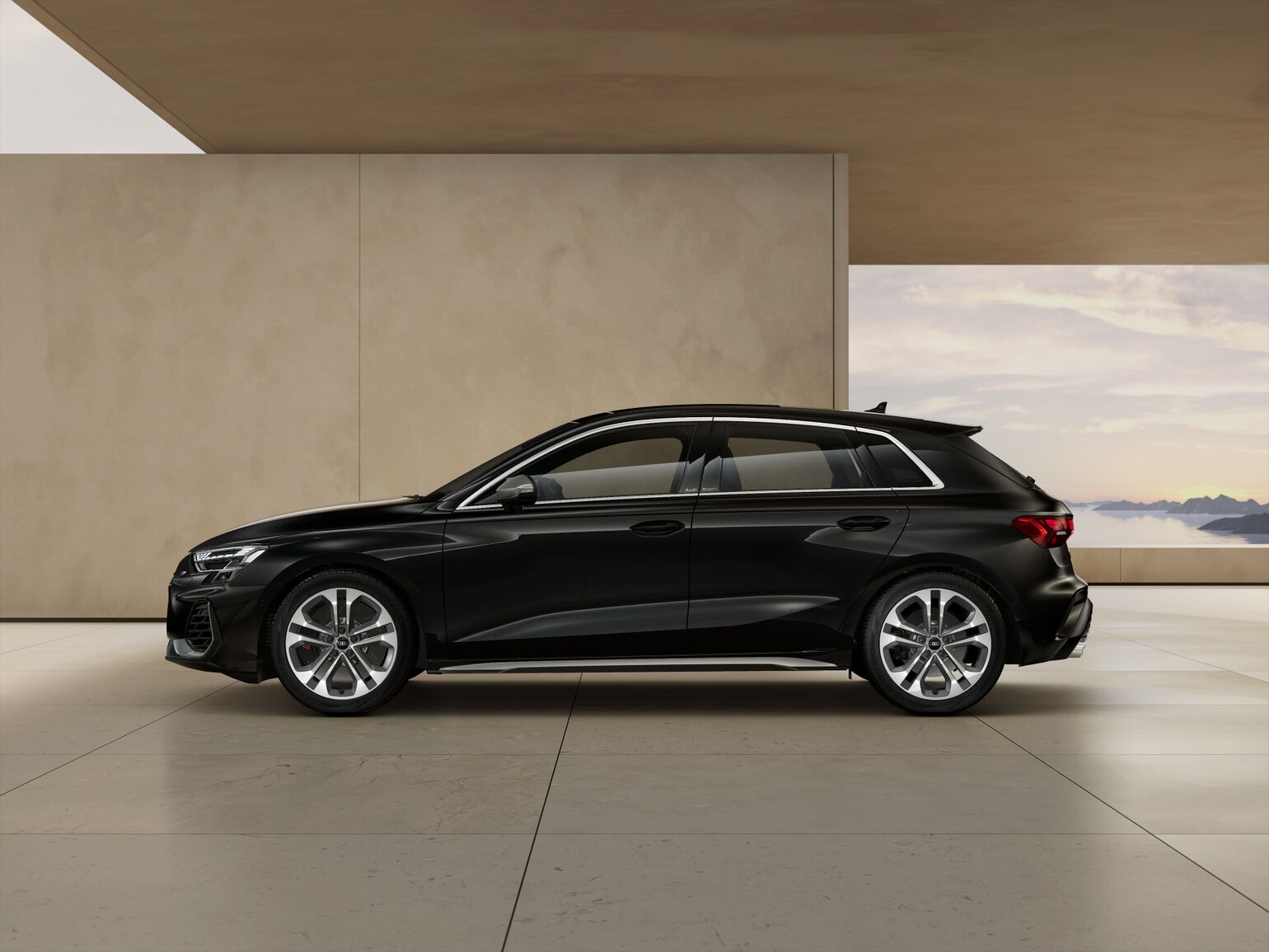 The dynamic Sportback silhouette is visible from the side. The exterior mirror housings in black and the red painted brake calipers with S logo enhance the vehicle’s exclusive appearance.