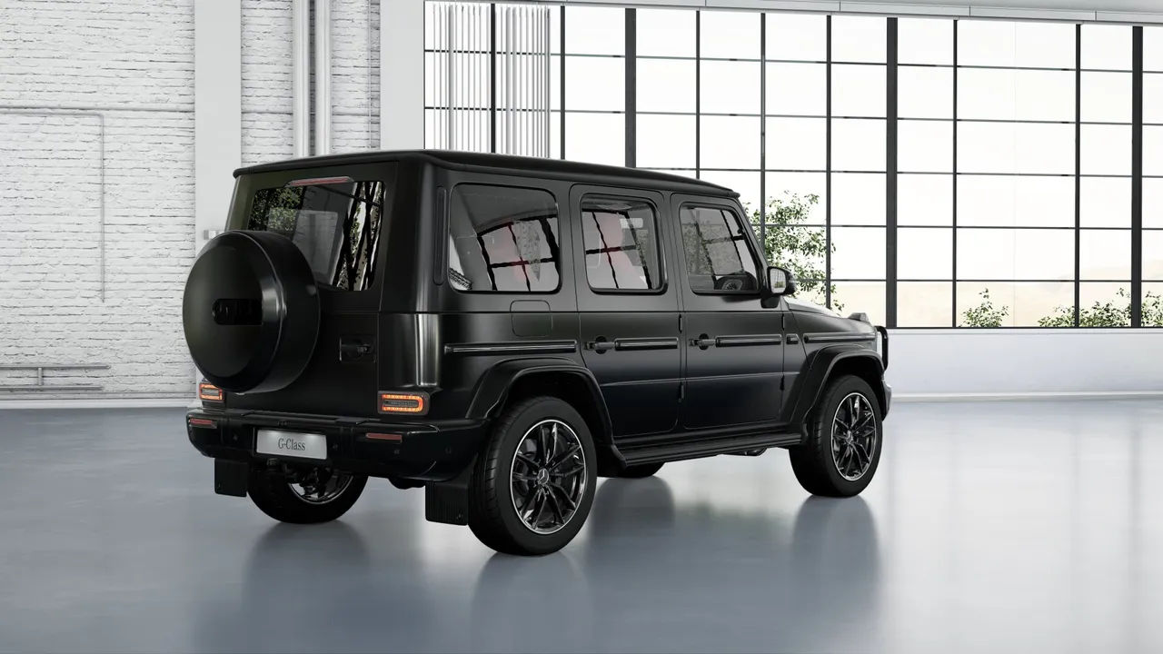 The G-Class`s distinct rear spare wheel, a classic feature, now blends flawlessly with the redesigned rear, elevating its commanding presence.