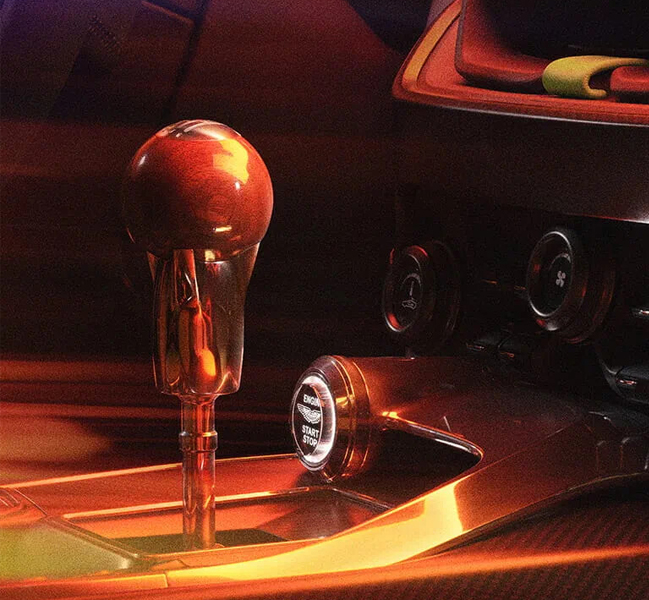 At the centre of Valour’s interior lies a beautifully-crafted, manual transmission gear lever, which effortlessly combined with ultra-modern materials such as lightweight mokume carbon fibre, leather grab handles, and exposed billet aluminium.
 
To embrace the heritage of the 1959 Le Mans challenger, Valour also incorporates DBR1 tweed, infusing a touch of timeless elegance into the design of its interior.