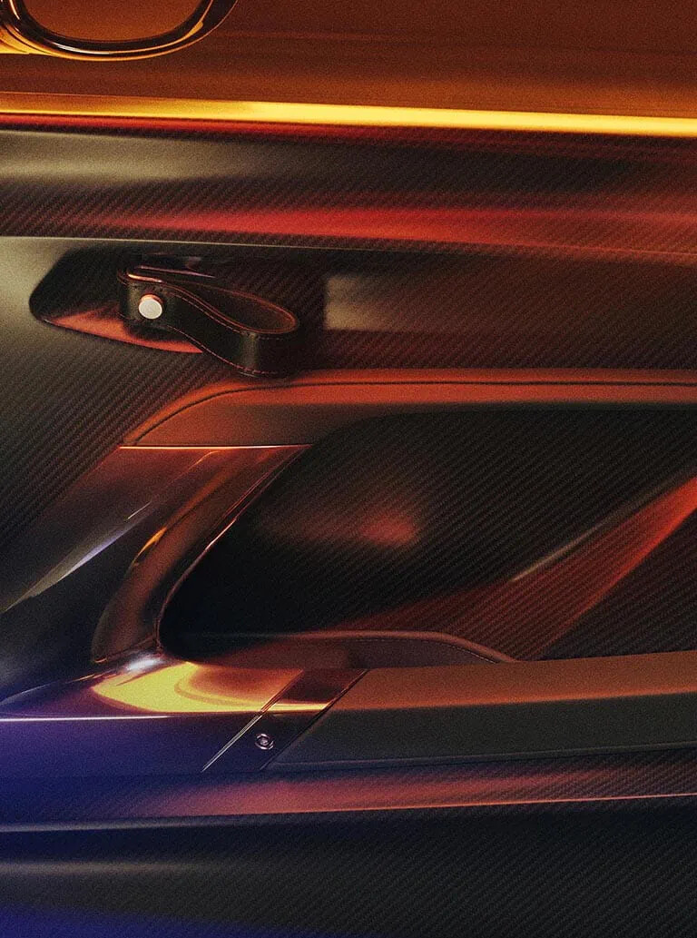 Lightweight carbon fiber is dominant throughout the cabin. From the meticulously crafted bespoke door cards to the upper center console and transmission tunnel, and the fascia air vents and performance seats, the material is exquisitely beautiful.