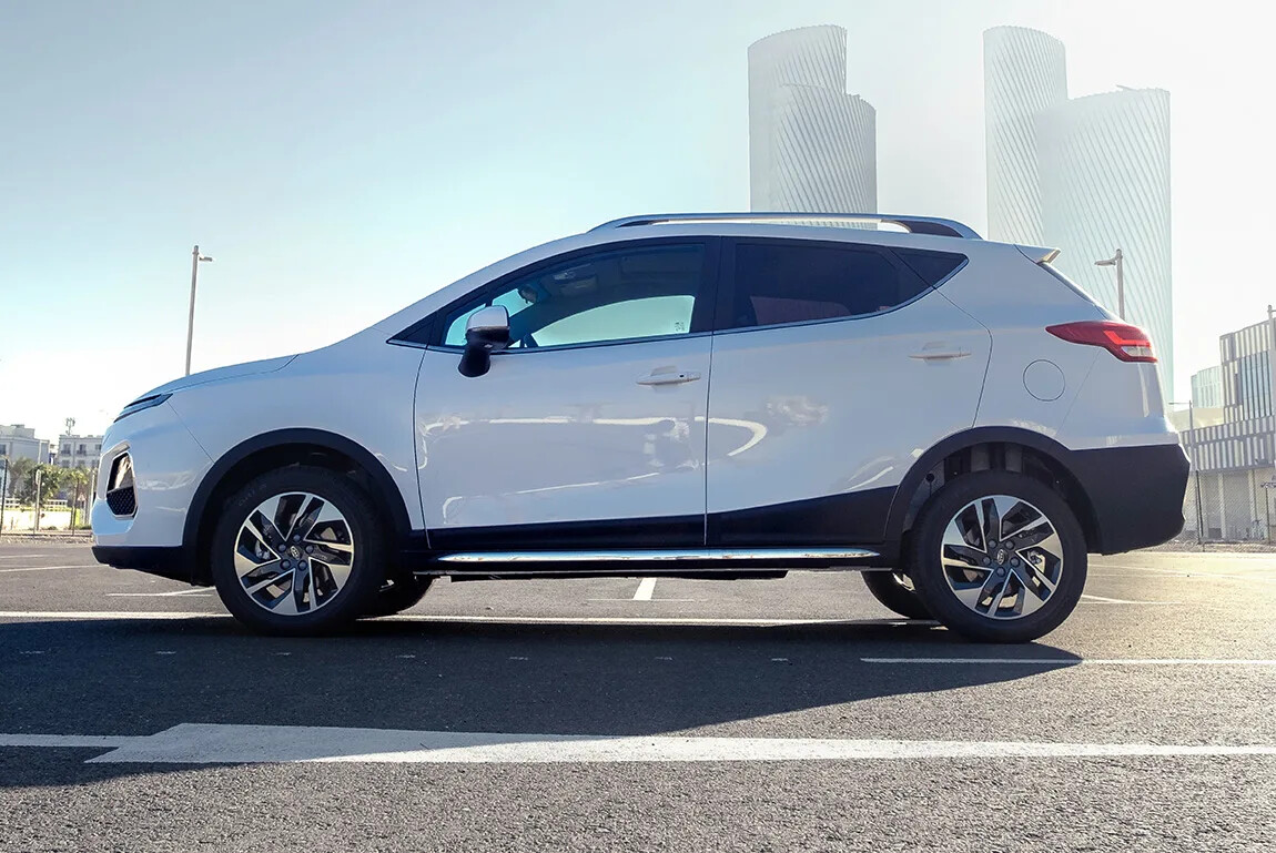 The vehicle’s side profile highlights its smooth curves and well-proportioned stance, while the roofline gently slopes, contributing to its sporty appeal.