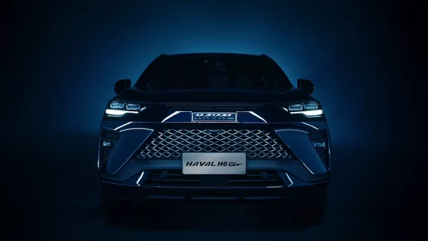 The front features a shark fin-inspired design and a grille resembling shark teeth, giving the vehicle a stylish and sharp appearance.